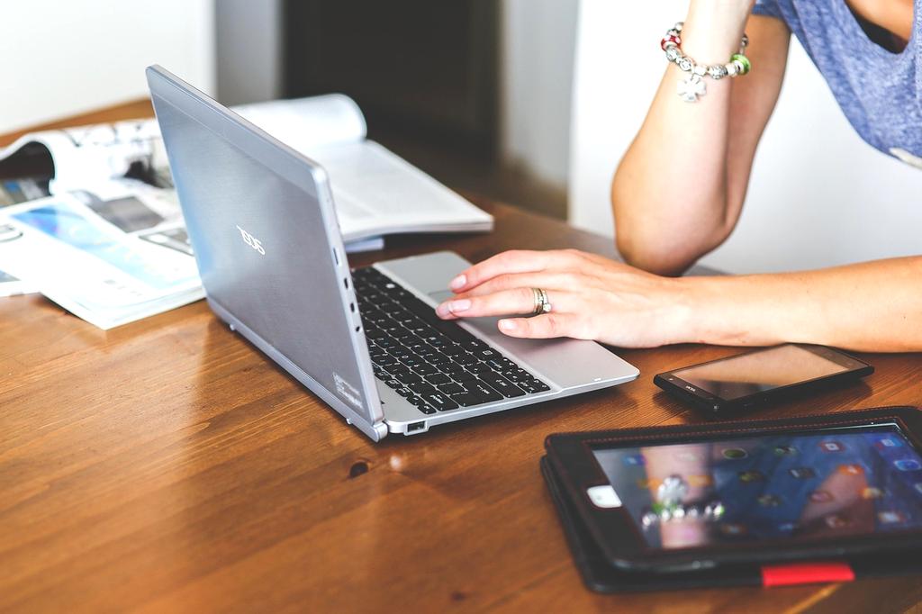 Social media interface on smartphone and laptop